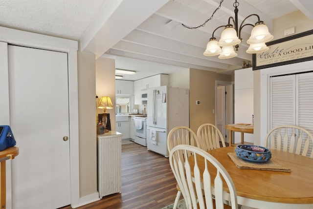 556 Weirs Blvd Unit 6, Laconia, NH 03246 - dining space featuring a chandelier, beamed ceiling, and dark wood finished floors