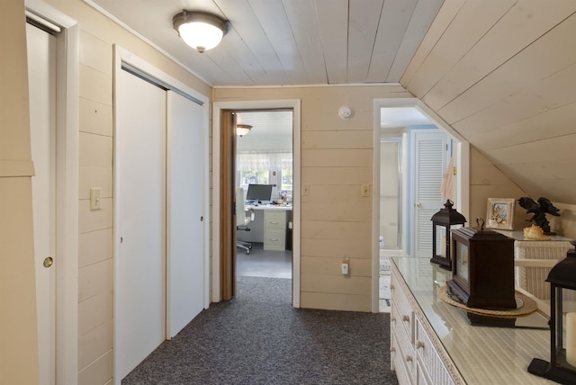 556 Weirs Blvd Unit 6, Laconia, NH 03246 - hall with wooden ceiling, dark carpet, vaulted ceiling, wood walls, and a desk