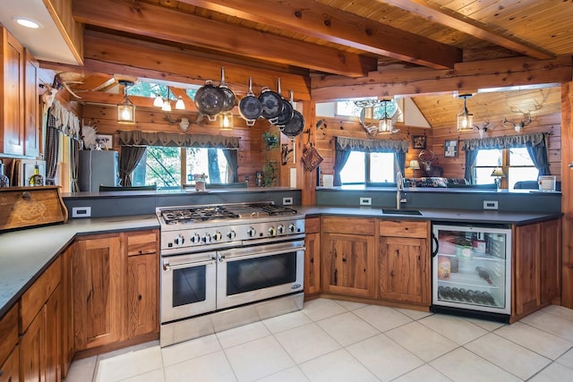 213 Singing Cedars Rd, Orwell, VT 05760 - kitchen with double oven range, a sink, wooden walls, brown cabinetry, and wood ceiling