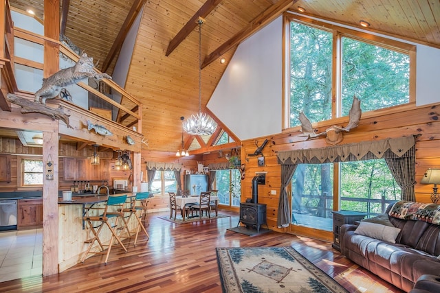 213 Singing Cedars Rd, Orwell, VT 05760 - living room with a wood stove, high vaulted ceiling, wooden ceiling with exposed beams, a chandelier, and wood-type flooring