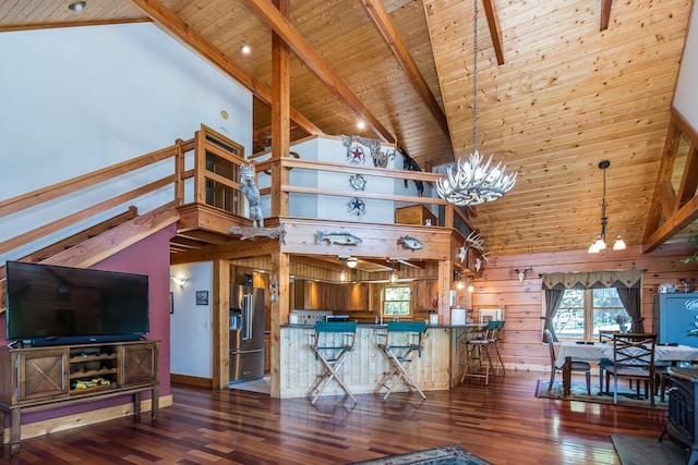 213 Singing Cedars Rd, Orwell, VT 05760 - living room with wood ceiling with exposed beams, high vaulted ceiling, a chandelier, wood finished floors, and wood walls
