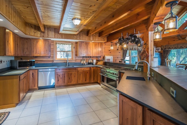 213 Singing Cedars Rd, Orwell, VT 05760 - kitchen featuring stainless steel appliances, a sink, brown cabinets, wood ceiling with exposed beams, and healthy amount of natural light