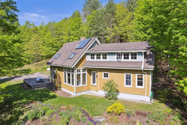44 Clarksville Rd, Tunbridge, VT 05077 - view of front facade featuring a chimney, a front lawn, a forest view, and a shingled roof
