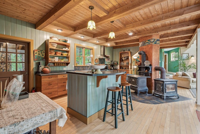 44 Clarksville Rd, Tunbridge, VT 05077 - kitchen featuring wood ceiling with exposed beams, wall chimney range hood, light wood-style flooring, dark countertops, and open shelves