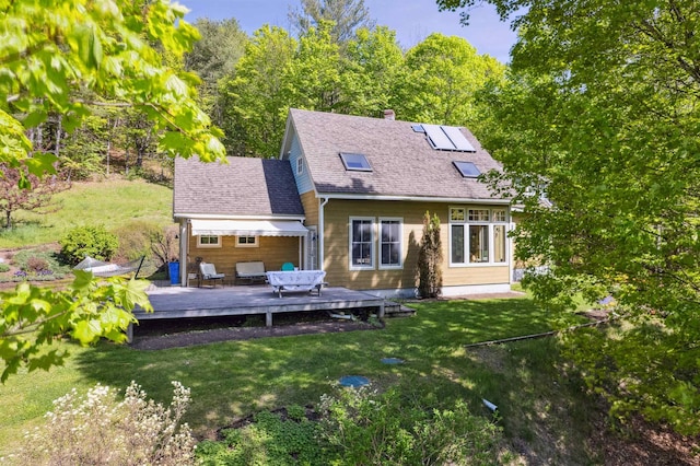 44 Clarksville Rd, Tunbridge, VT 05077 - back of property featuring a yard, a wooden deck, a chimney, and roof with shingles