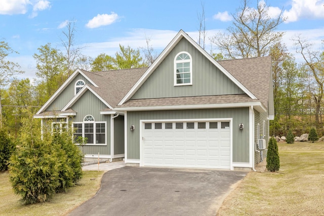 280 Sterling Dr, Laconia, NH 03246 - view of front of house featuring a shingled roof, asphalt driveway, a garage, and a front lawn