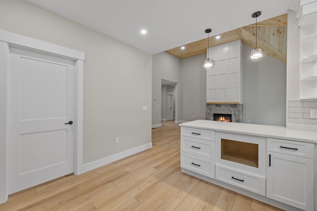280 Sterling Dr, Laconia, NH 03246 - kitchen with white cabinetry, light wood-style floors, decorative light fixtures, light countertops, and open shelves