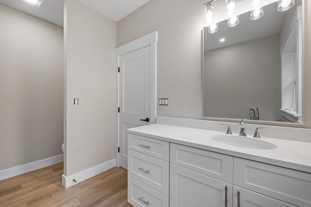 280 Sterling Dr, Laconia, NH 03246 - bathroom with toilet, vanity, wood finished floors, and baseboards