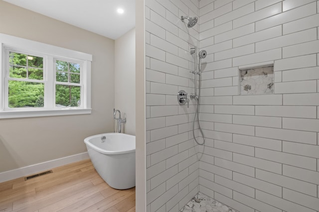 280 Sterling Dr, Laconia, NH 03246 - full bathroom featuring baseboards, tiled shower, a soaking tub, wood finished floors, and recessed lighting