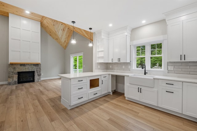 280 Sterling Dr, Laconia, NH 03246 - kitchen featuring a sink, a peninsula, tasteful backsplash, light countertops, and recessed lighting