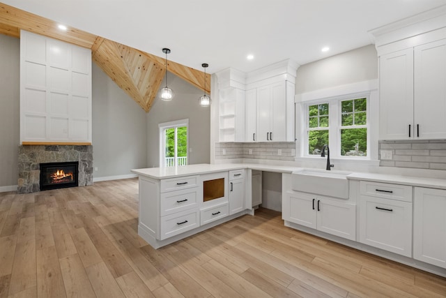 280 Sterling Dr, Laconia, NH 03246 - kitchen featuring a sink, a peninsula, tasteful backsplash, light countertops, and recessed lighting