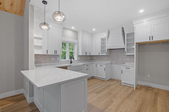 280 Sterling Dr, Laconia, NH 03246 - kitchen featuring a peninsula, a sink, custom exhaust hood, tasteful backsplash, and recessed lighting