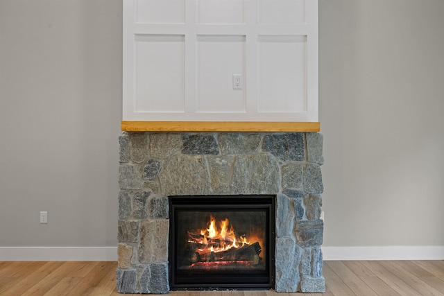 280 Sterling Dr, Laconia, NH 03246 - detailed view of a fireplace, baseboards, and wood finished floors