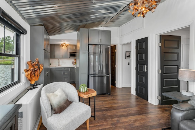 556 Weirs Blvd Unit 4, Laconia, NH 03246 - living area featuring dark wood finished floors, vaulted ceiling, and a chandelier