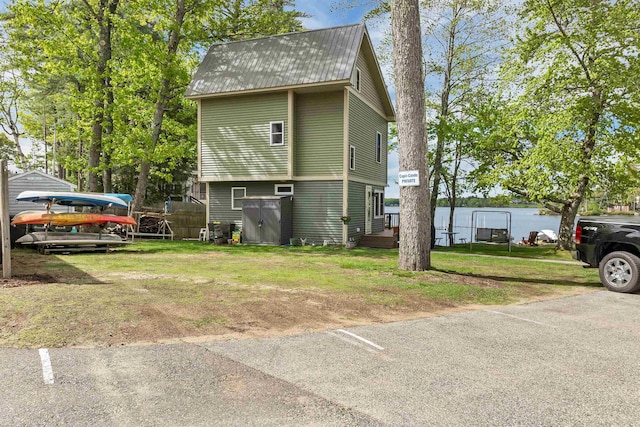 556 Weirs Blvd Unit 4, Laconia, NH 03246 - view of home's exterior with metal roof and a lawn
