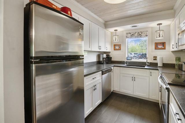 6049 Mountain Rd Unit 20, Stowe, VT 05672 - kitchen with appliances with stainless steel finishes, dark countertops, a sink, backsplash, and crown molding