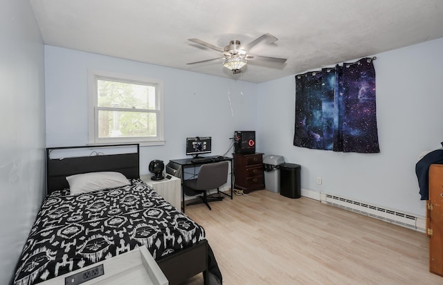 11 Riverside Dr, Rochester, NH 03867 - bedroom with a baseboard heating unit, wood finished floors, ceiling fan, and a desk