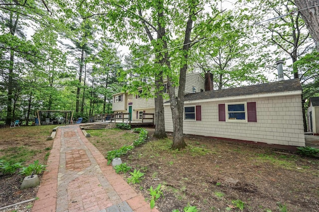 11 Riverside Dr, Rochester, NH 03867 - view of side of home with a chimney and a wooden deck