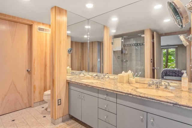 75 Westwood Rd, Sunapee, NH 03782 - bathroom with double vanity, a tile shower, toilet, connected bathroom, and tile patterned floors