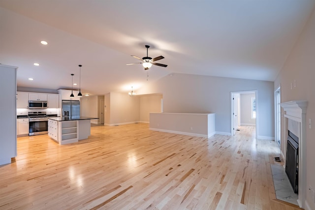 153 Ann Marie Ln, Colchester, VT 05446 - unfurnished living room featuring ceiling fan, light wood finished floors, recessed lighting, a fireplace, and lofted ceiling