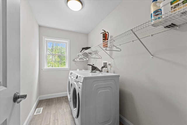 153 Ann Marie Ln, Colchester, VT 05446 - washroom with washer and clothes dryer, light wood-style floors, and baseboards