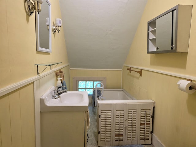 66 Union St, Windsor, VT 05089 - full bath featuring lofted ceiling, vanity, a garden tub, and wainscoting