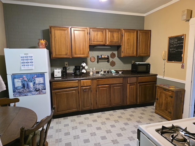 66 Union St, Windsor, VT 05089 - kitchen with white appliances, a sink, crown molding, light floors, and brown cabinetry