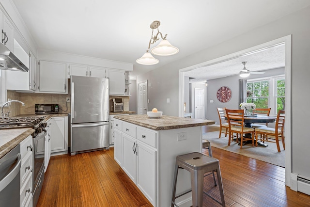 11 Beauchesne Dr, Hooksett, NH 03106 - kitchen with appliances with stainless steel finishes, a baseboard heating unit, dark wood-style flooring, and white cabinets