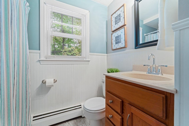 11 Beauchesne Dr, Hooksett, NH 03106 - bathroom with a baseboard radiator, wainscoting, toilet, vanity, and a shower with shower curtain