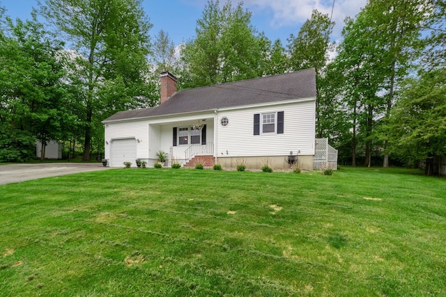 11 Beauchesne Dr, Hooksett, NH 03106 - view of front of property featuring a garage, asphalt driveway, a front lawn, and a chimney