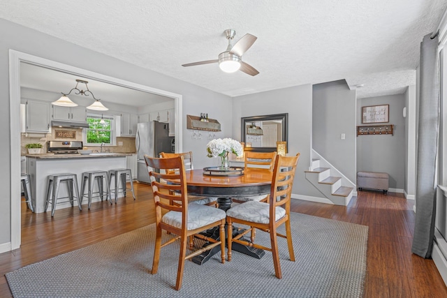 11 Beauchesne Dr, Hooksett, NH 03106 - dining room featuring dark wood finished floors, a ceiling fan, baseboards, and a textured ceiling
