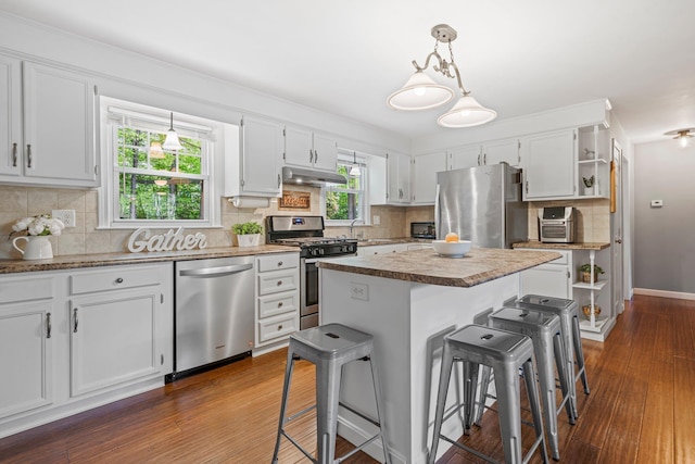 11 Beauchesne Dr, Hooksett, NH 03106 - kitchen with stainless steel appliances, under cabinet range hood, open shelves, a kitchen bar, and a center island
