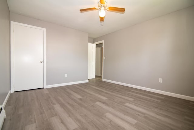 82 S Jewett St, Manchester, NH 03103 - empty room featuring wood finished floors, baseboards, a ceiling fan, and baseboard heating