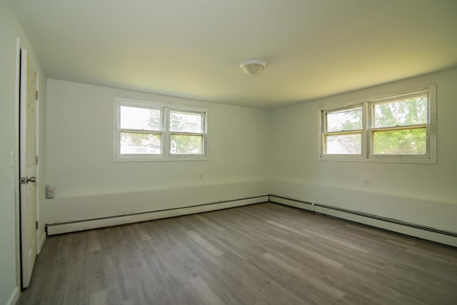 82 S Jewett St, Manchester, NH 03103 - unfurnished room with healthy amount of natural light, wood finished floors, and a baseboard heating unit