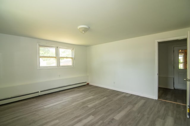 82 S Jewett St, Manchester, NH 03103 - spare room featuring baseboard heating, wood finished floors, and baseboards