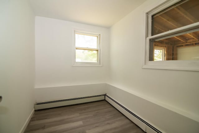 82 S Jewett St, Manchester, NH 03103 - empty room featuring healthy amount of natural light, baseboard heating, and wood finished floors