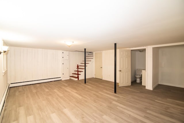 82 S Jewett St, Manchester, NH 03103 - finished below grade area featuring stairway, light wood finished floors, a baseboard radiator, and baseboards