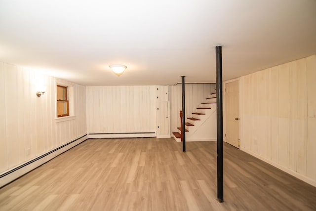 82 S Jewett St, Manchester, NH 03103 - finished basement with a baseboard heating unit, light wood-style flooring, and stairs