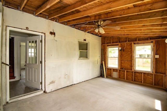 82 S Jewett St, Manchester, NH 03103 - unfurnished room featuring healthy amount of natural light, concrete floors, and a ceiling fan