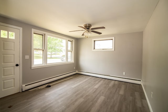 82 S Jewett St, Manchester, NH 03103 - unfurnished room featuring a baseboard heating unit, healthy amount of natural light, and dark wood-style floors
