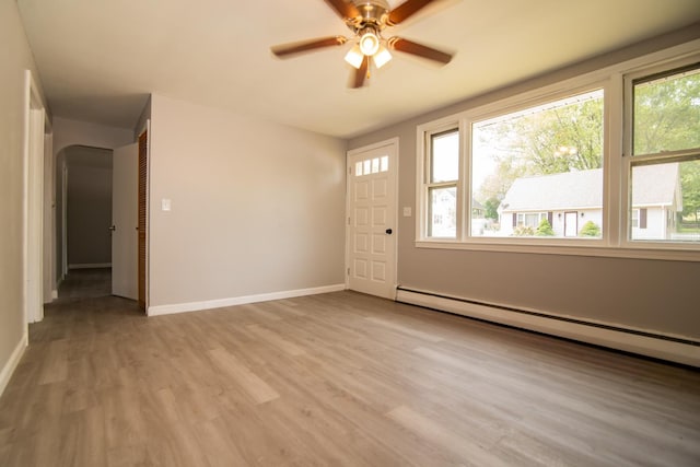 82 S Jewett St, Manchester, NH 03103 - entryway with a baseboard radiator, light wood finished floors, ceiling fan, baseboards, and arched walkways