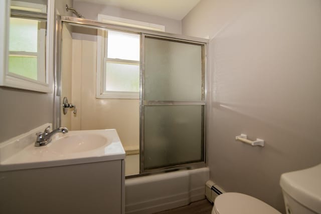 82 S Jewett St, Manchester, NH 03103 - bathroom with toilet, plenty of natural light, vanity, and a baseboard heating unit