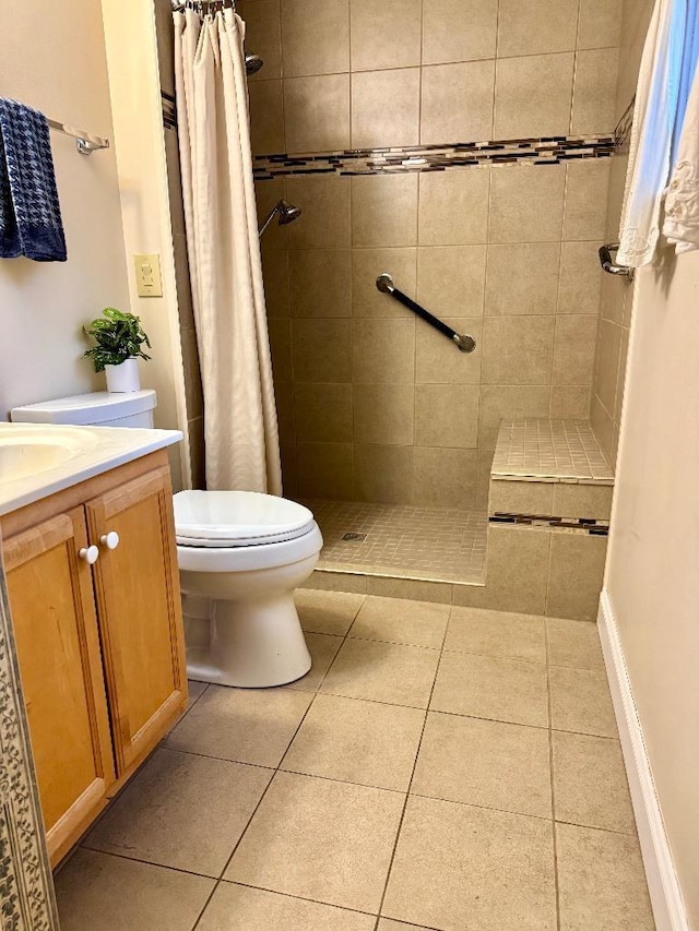 1 Stannard Dr, Essex, VT 05452 - bathroom with toilet, tiled shower, vanity, and tile patterned floors