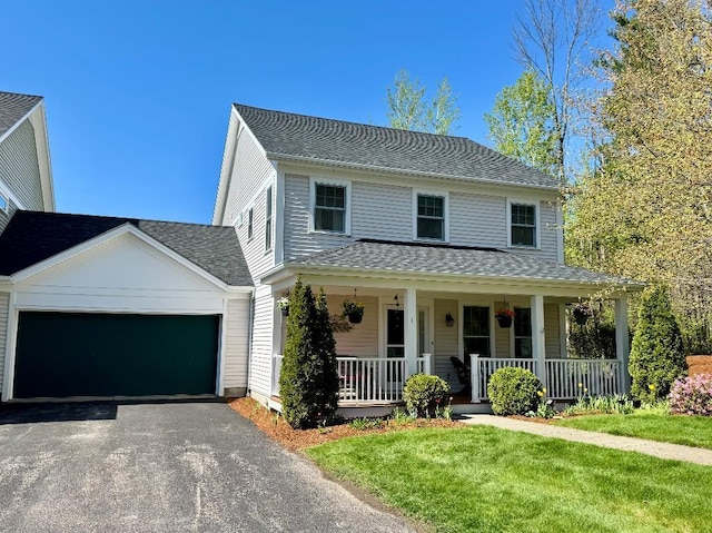1 Stannard Dr, Essex, VT 05452 - view of front of property featuring a garage, driveway, a porch, roof with shingles, and a front yard