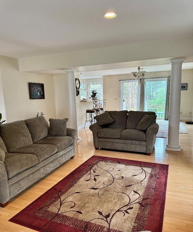 1 Stannard Dr, Essex, VT 05452 - living area with decorative columns, light wood-type flooring, a chandelier, recessed lighting, and baseboards