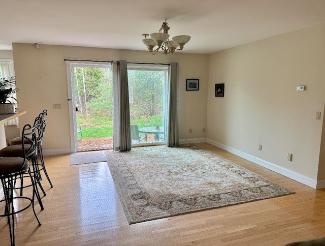 1 Stannard Dr, Essex, VT 05452 - dining area featuring a chandelier, baseboards, and light wood-style flooring