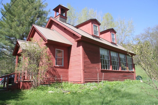 2884 Tampico Rd, Danville, VT 05828 - view of side of property featuring a chimney, metal roof, and a lawn
