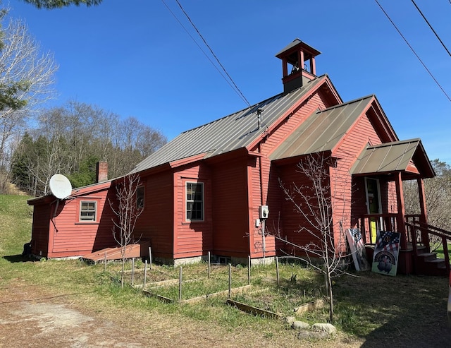 2884 Tampico Rd, Danville, VT 05828 - view of side of home featuring a chimney, a garden, and metal roof