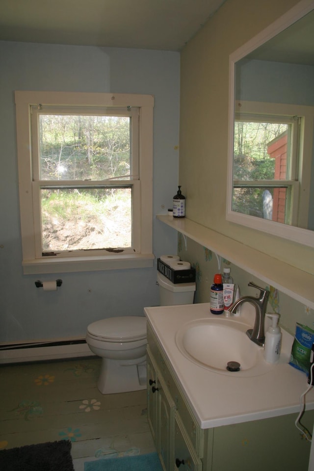 2884 Tampico Rd, Danville, VT 05828 - bathroom featuring a baseboard radiator, vanity, toilet, and plenty of natural light