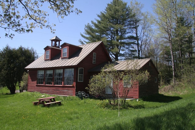 2884 Tampico Rd, Danville, VT 05828 - rear view of property with a standing seam roof, metal roof, and a yard